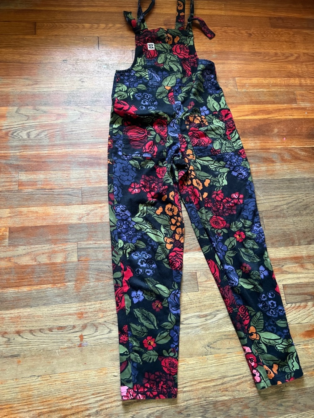 Lucy & Yak Black Floral Tie-Shoulder Overalls with Red, Green & Blue Blooms